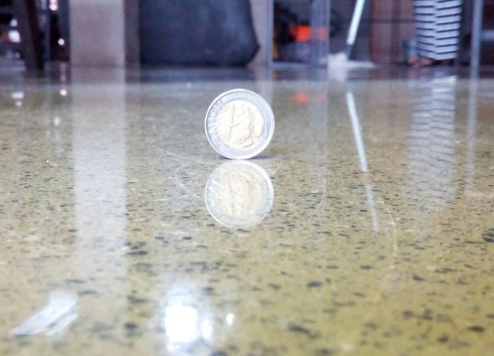 polished concrete flooring with a coin on top