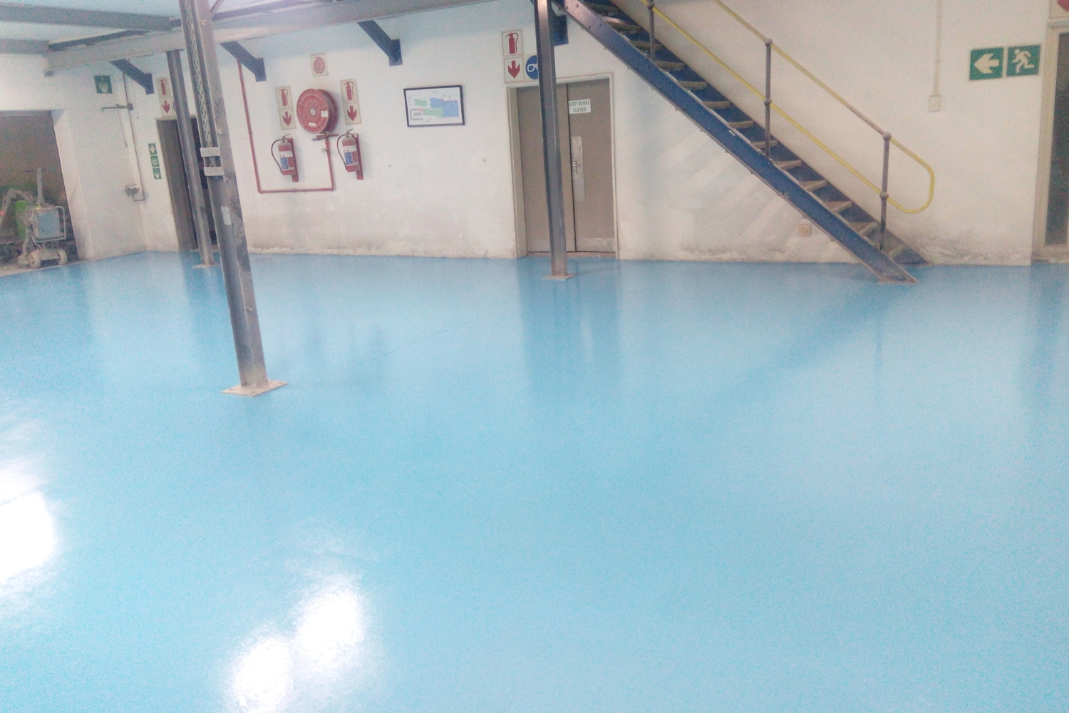 Factory floor finished in blue epoxy.